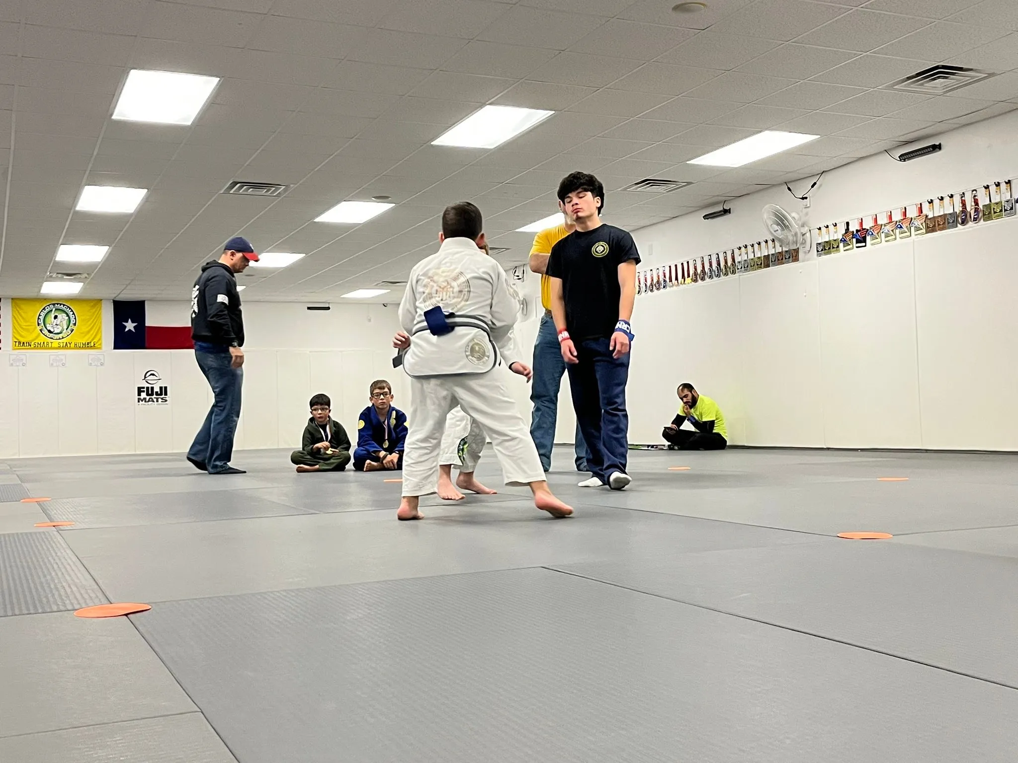 Kids Jiu-Jitsu students drilling a takedown in the Gi at Dynamic Martial Arts in Wichita Falls, TX